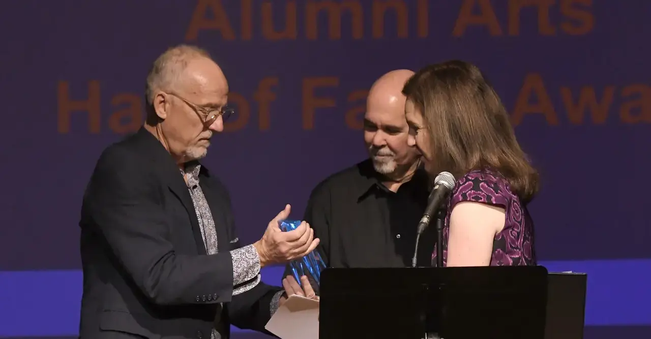 Alumni Arts Hall of fame recipient collecting their award.