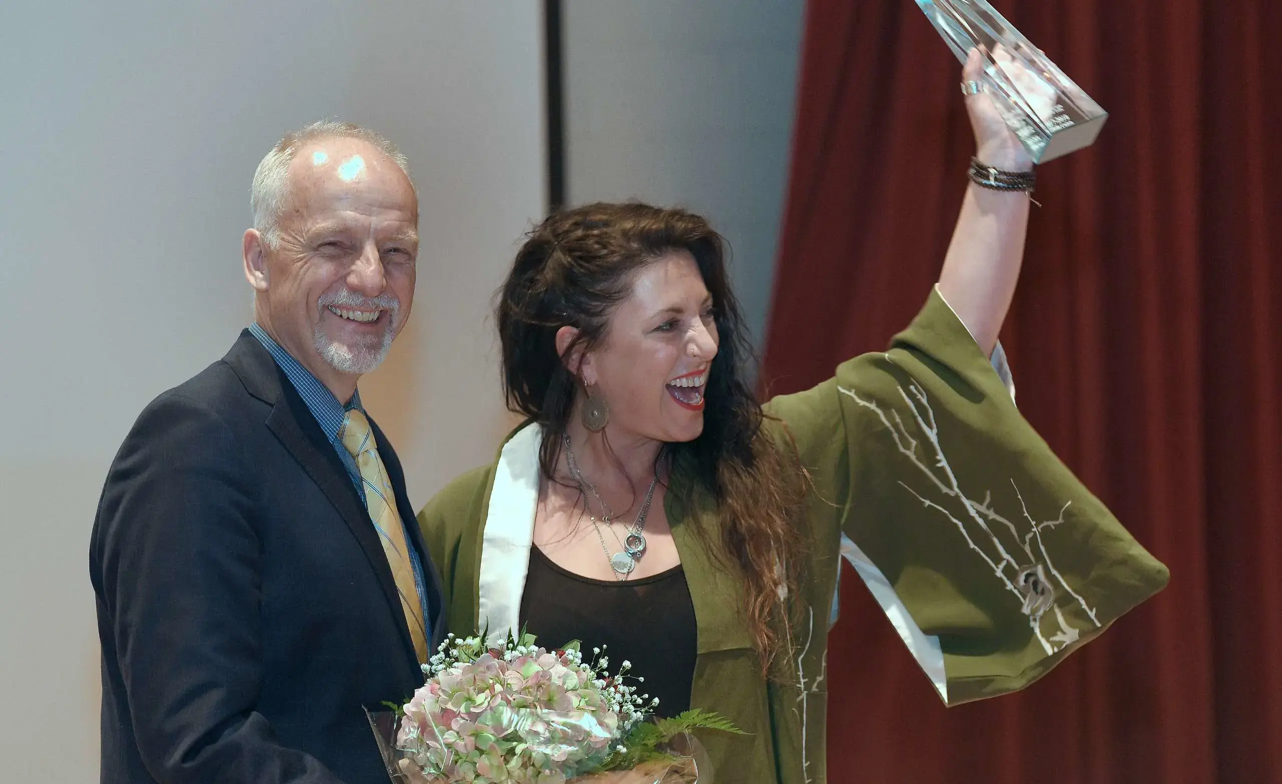 ULS Alumni holding their Alumni Arts Hall Of Fame award.