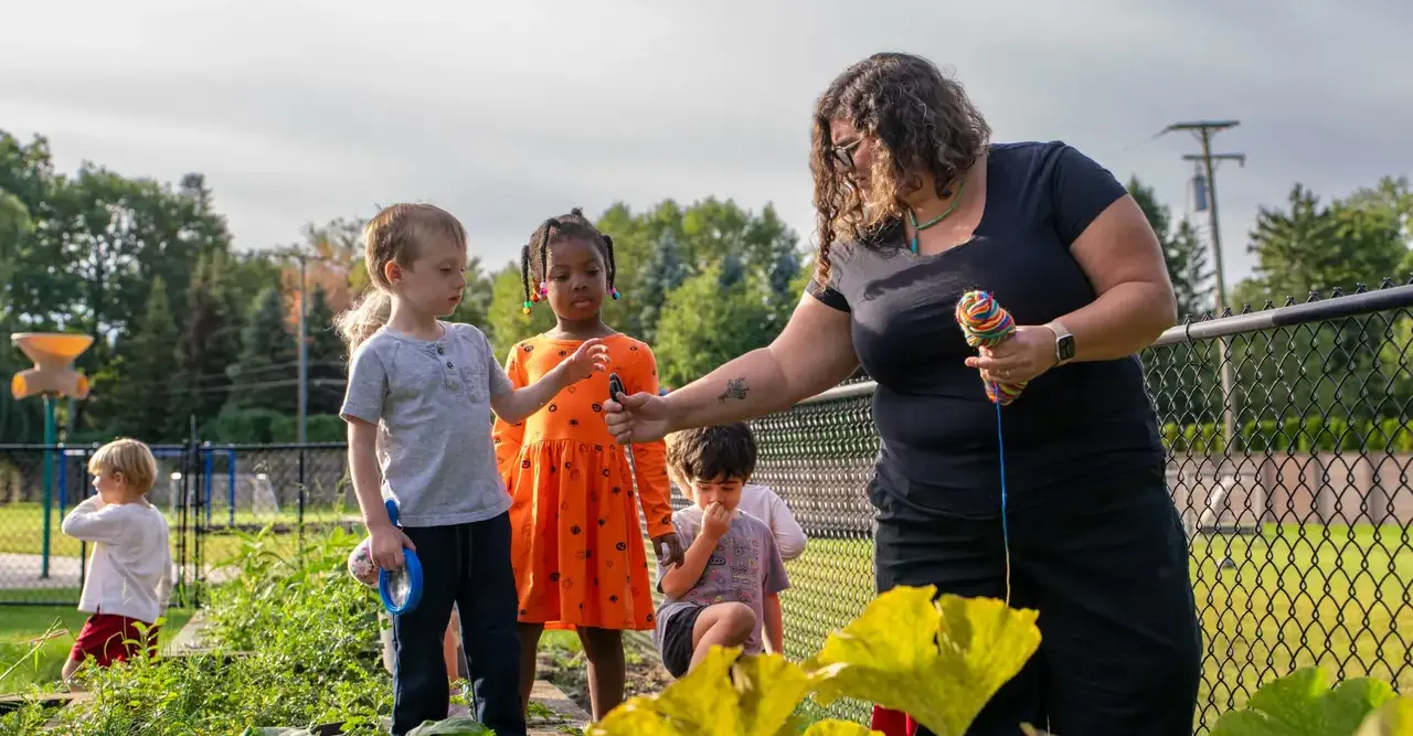 children and teacher in garden