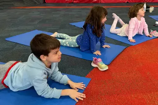 Early school pupils doing yoga