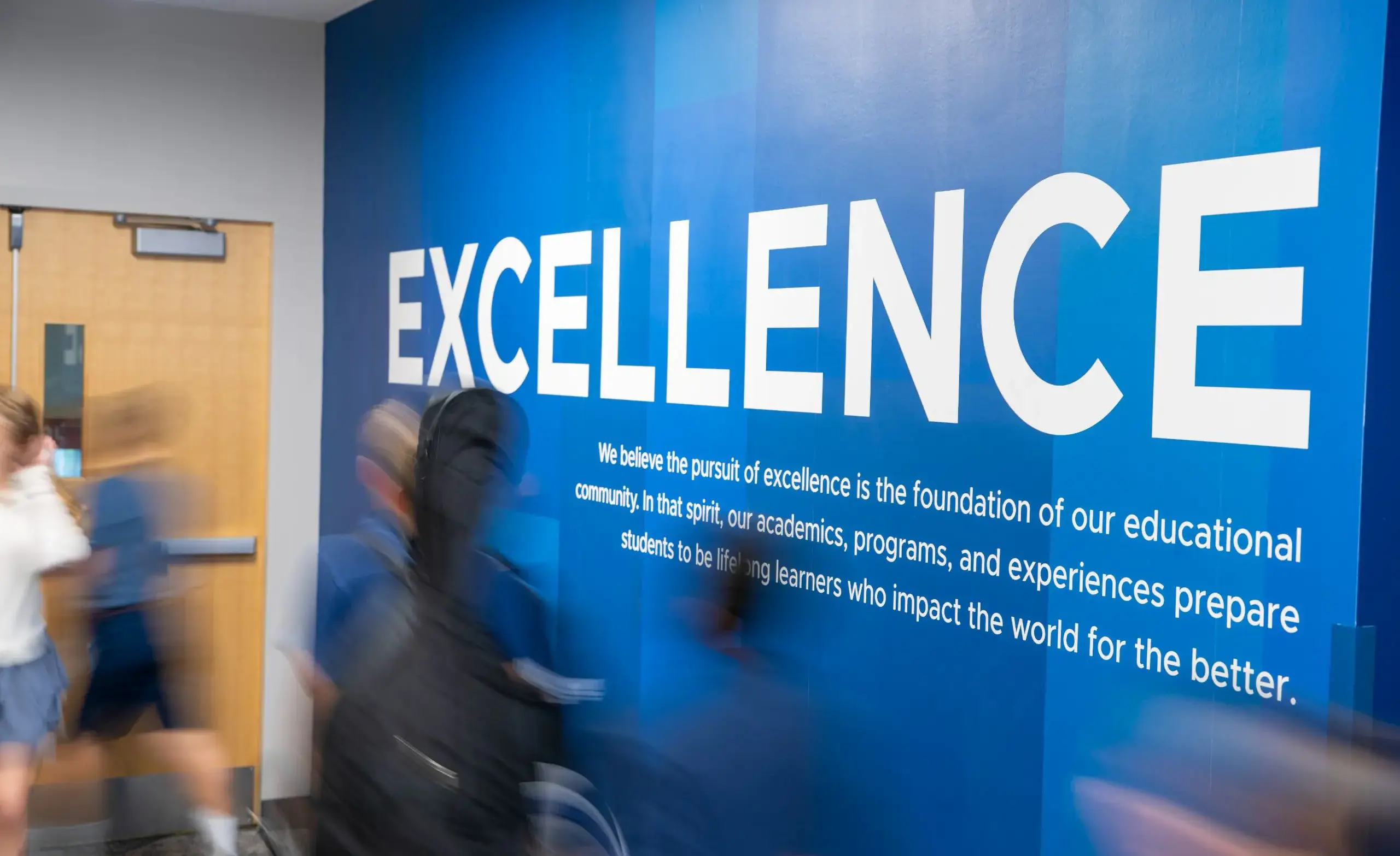 Photograph of ULS hallway with a wall reading 'Excellence'.
