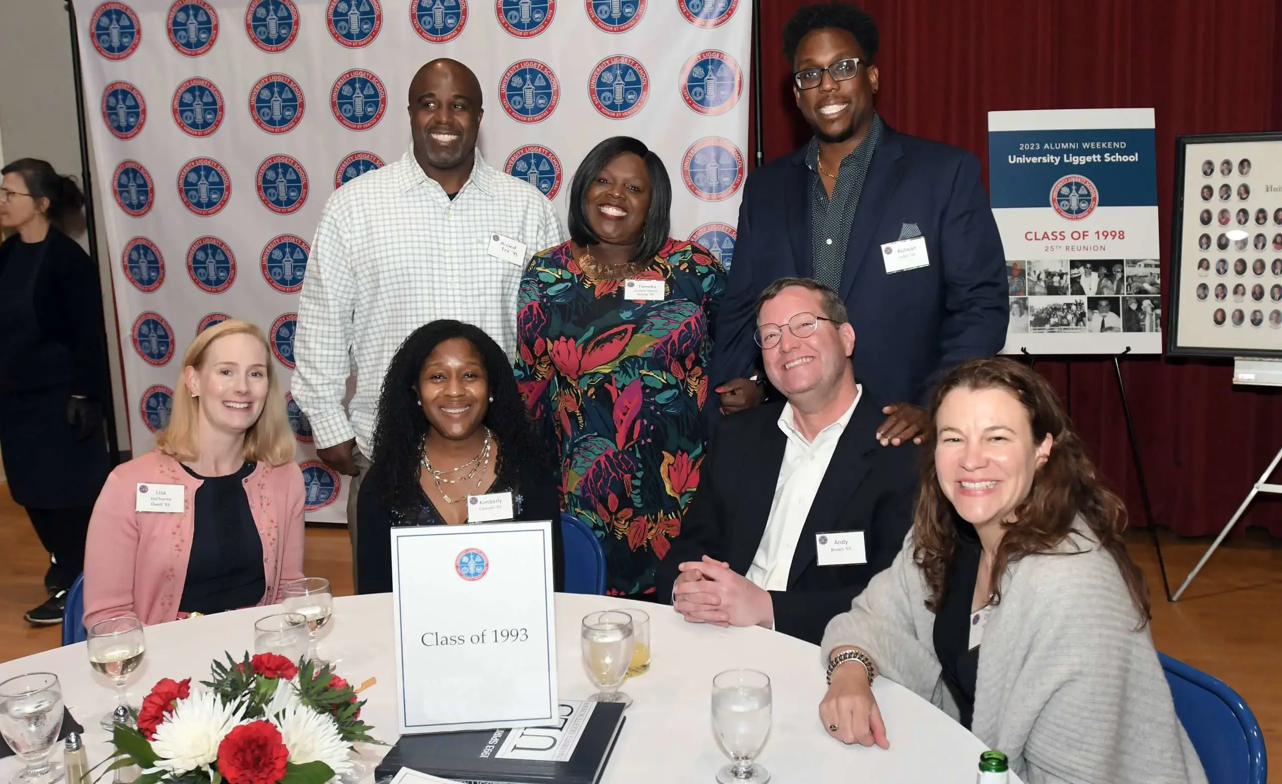 A group of smiling, happy, engaged alumni