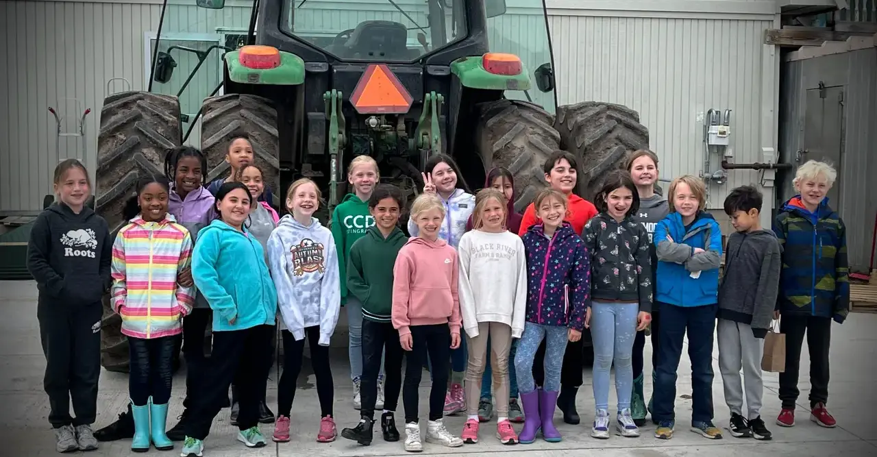 children in front of a tractor