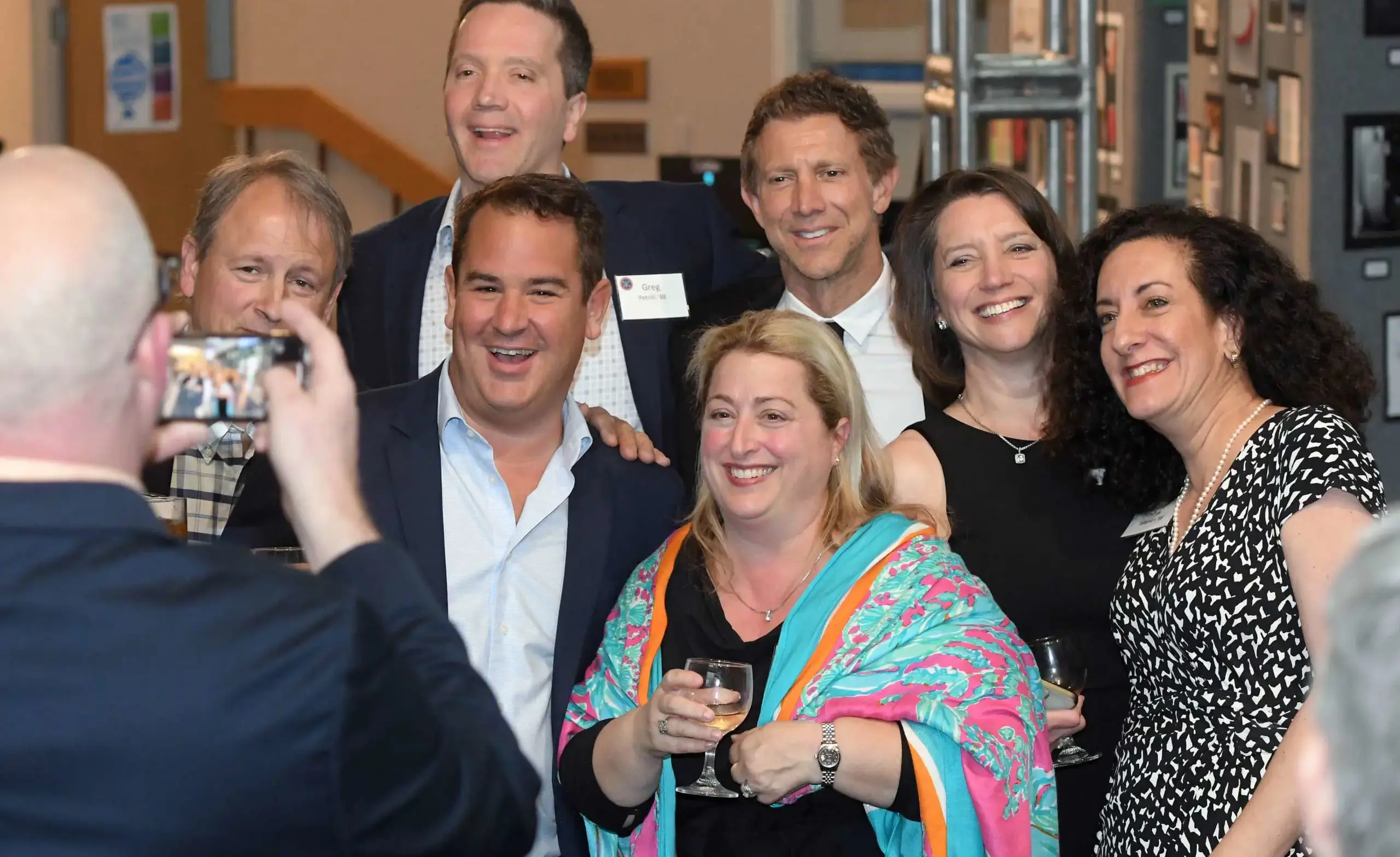 A group of smiling, happy, engaged alumni