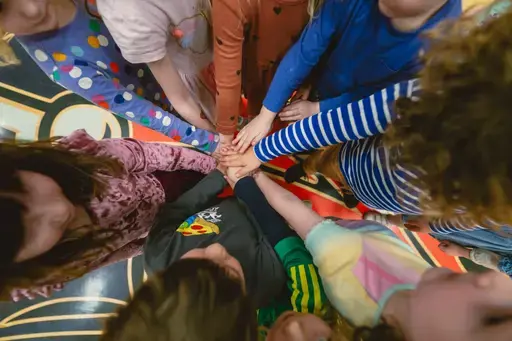 students hands in the middle