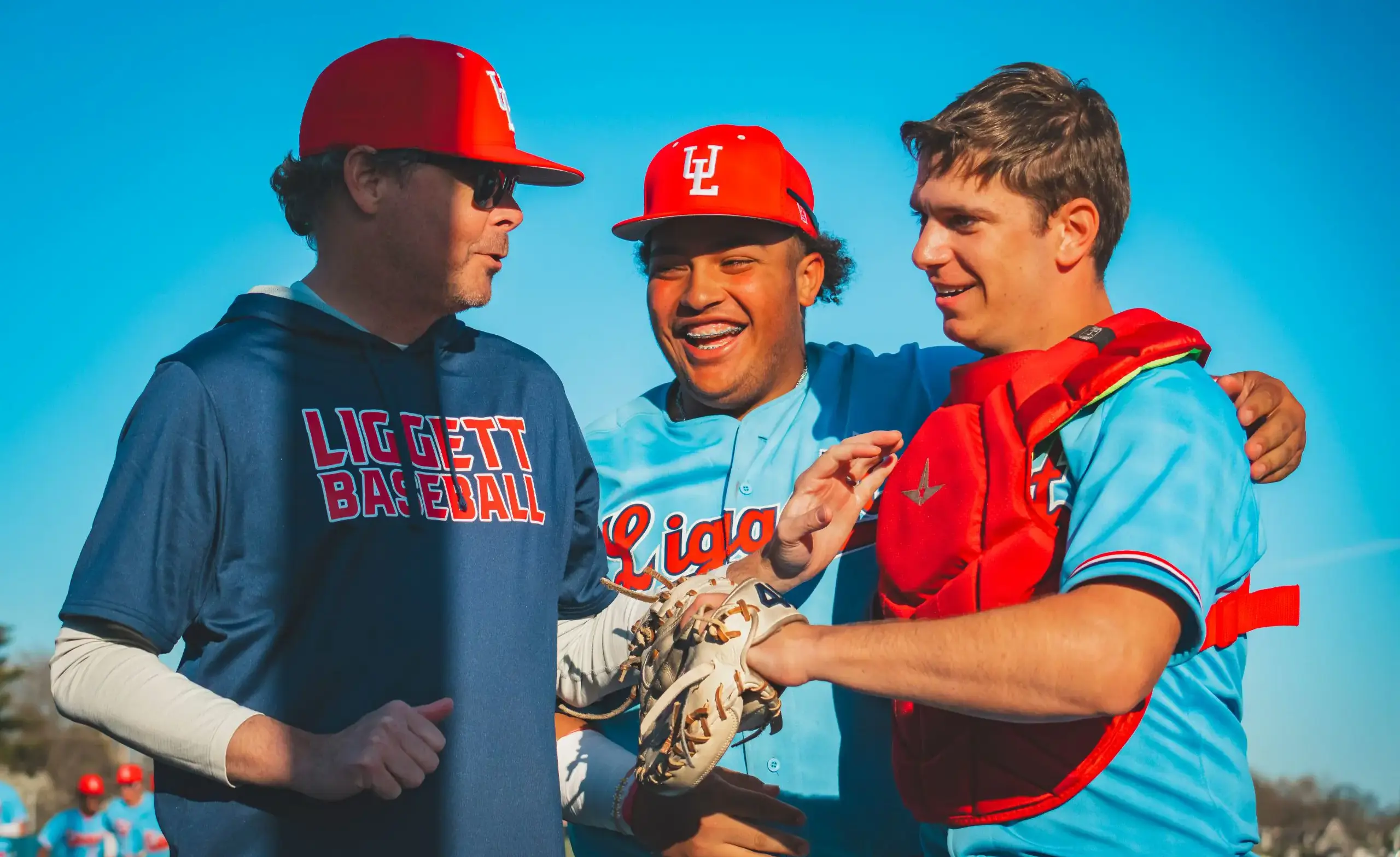 Baseball coach interacting with baseball players
