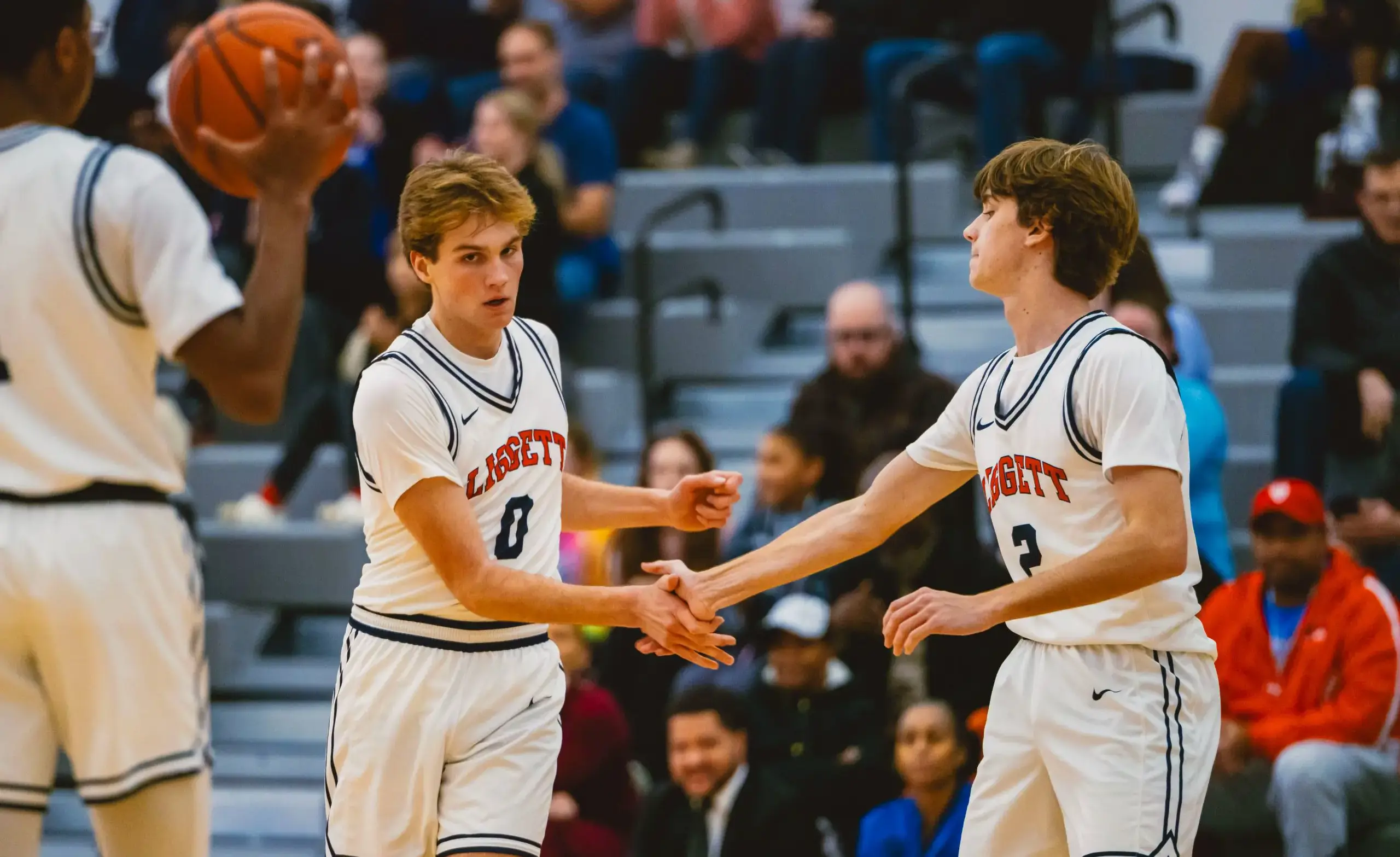 Boys basketball players high five