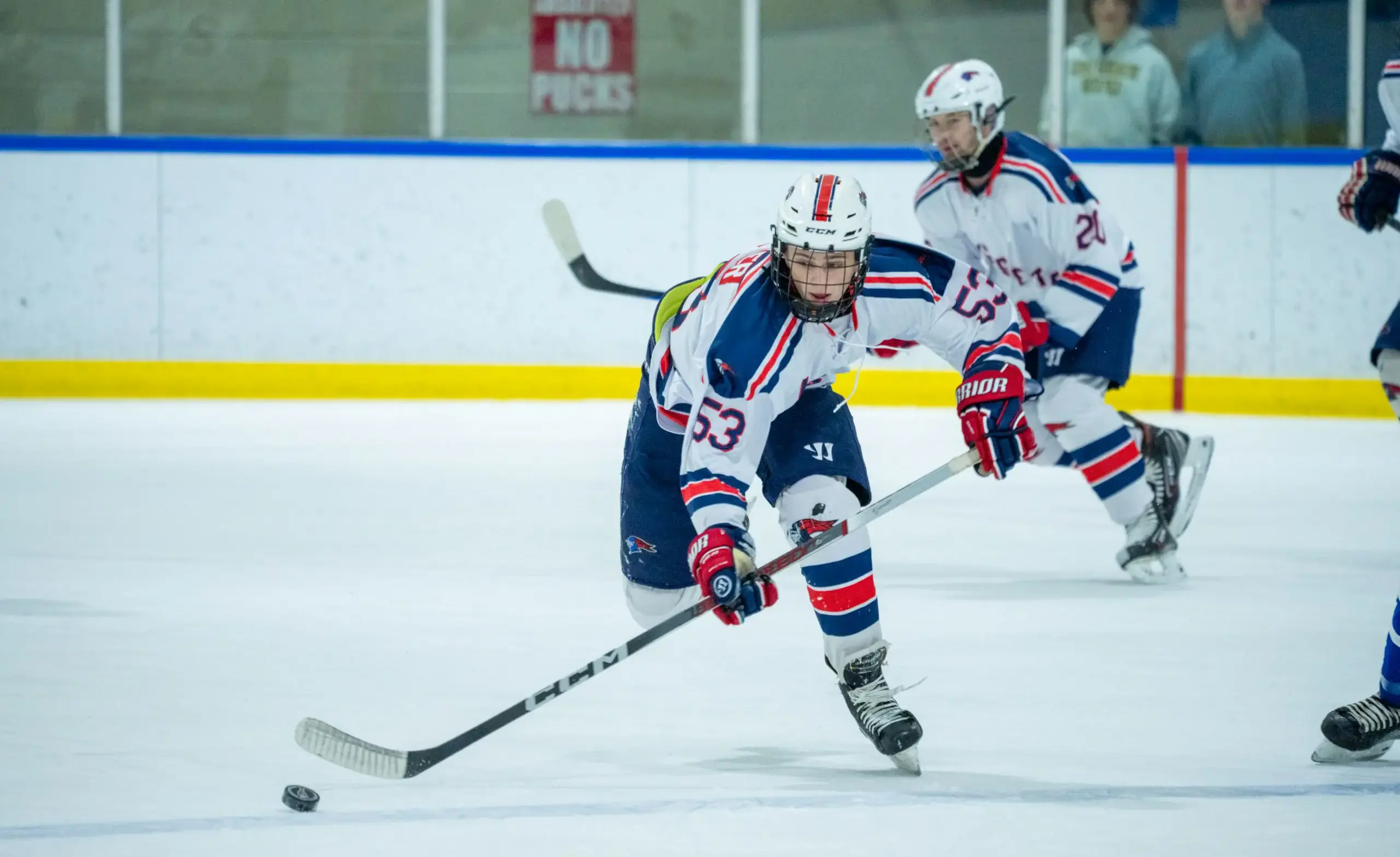 Hockey player skates toward puck