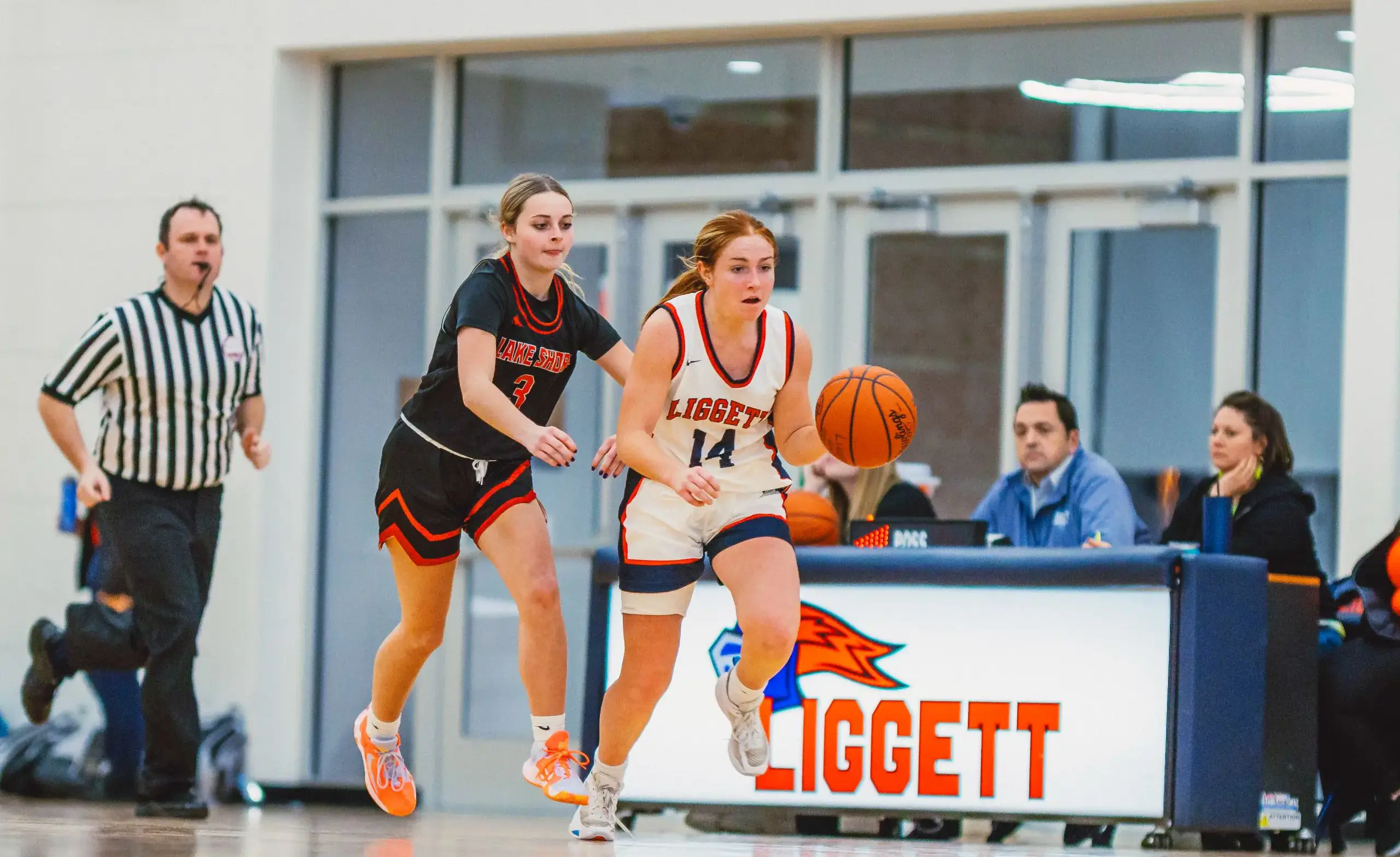 Girl basketball player dribbles the ball runs down the court