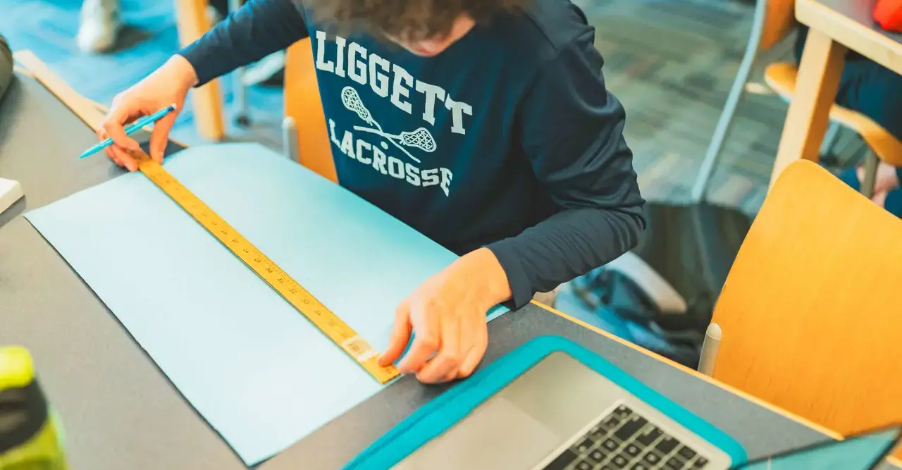 Student measuring paper